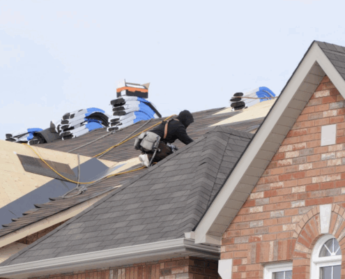 Roofers installing new shingles on a residential home in Pennsylvania to prepare for solar panel installation by Canopy Solar