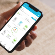 Solar system monitoring app on smartphone showing real-time solar production, battery storage, and home energy usage in the Enphase app.